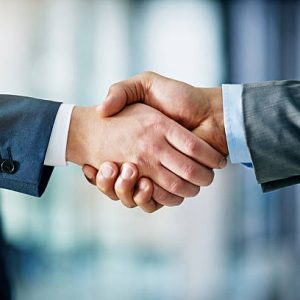 Closeup shot of two businessmen shaking hands in an office New Jersey Commercial Roofing